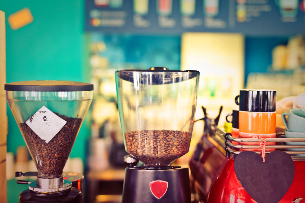 Three coffee machines with coffee beans inside. 